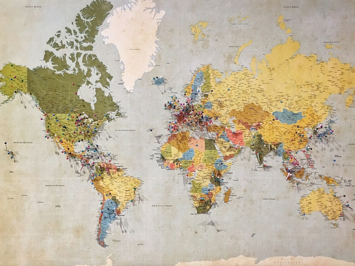 A detailed world map marked with pins